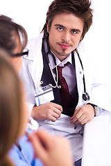 Image showing Young doctor sitting with hospital staff