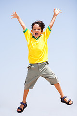 Image showing Smart kid jumping high in air