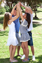Image showing Group of happy friends with raised arms