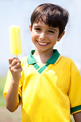 Image showing Smiling kid holding an ice-cream