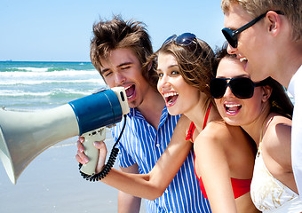 Image showing Teenagers shouting through megaphone
