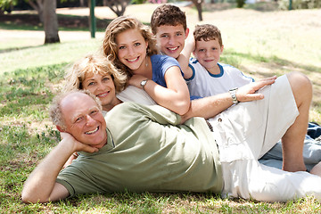 Image showing Family lying  in the park