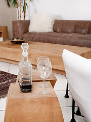 Image showing Champagne glasses with modern couch in background