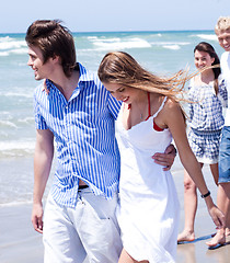 Image showing Romantic couples walking down the beach