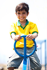 Image showing Young kid enjoying swing ride
