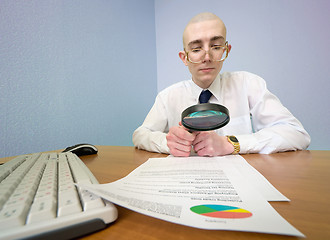 Image showing Boss with a magnifier on a workplace