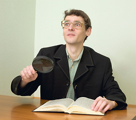 Image showing Guy in eyeglasses reads the book