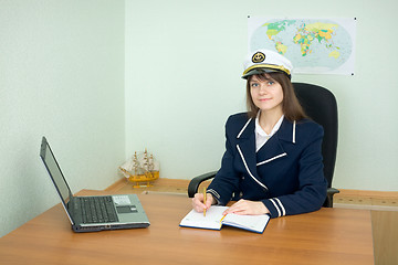 Image showing Girl - sea captain at office with laptop