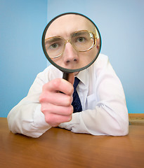 Image showing Man with a magnifier in a hand