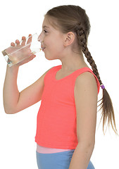 Image showing Girl drinks water from a glass