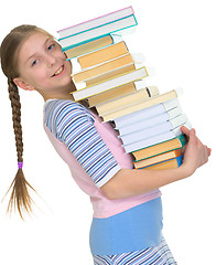 Image showing Schoolgirl with the big pile of books in hands