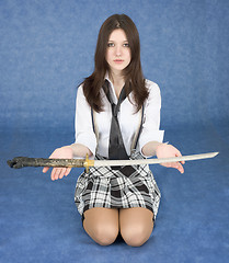 Image showing Girl sitting in a lap stretches us a sword