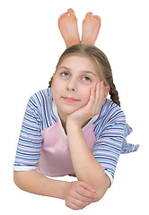 Image showing Girl in a T-shirt lies on a white