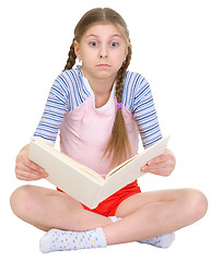 Image showing Surprised girl with the book in hands