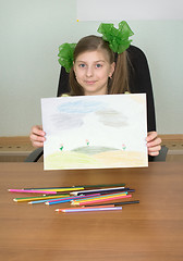 Image showing Smiling girl shows new drawing to us