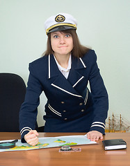 Image showing Girl in the form of captain punches a table