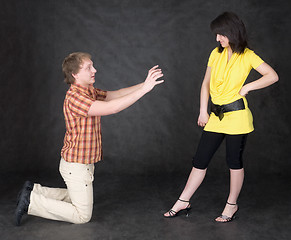 Image showing Man is kneeling to the young woman