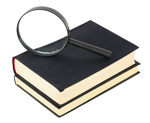 Image showing Two black books and magnifier glass on white