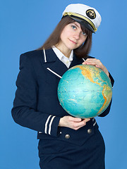 Image showing Woman in sea uniform and globe