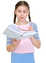 Image showing Schoolgirl reads the book on a white