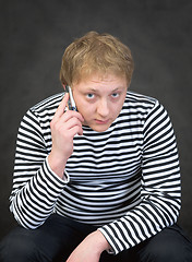 Image showing Seaman in a stripped vest with a mobile phone