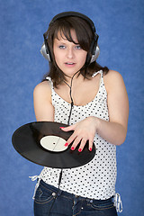 Image showing Girl in ear-phones with a phonograph record