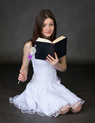 Image showing Girl with the book and a magic wand