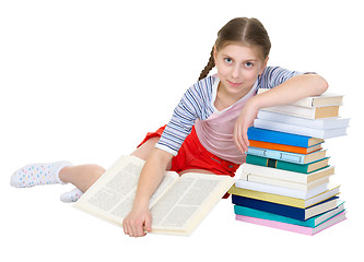 Image showing Girl sits having leant the elbows on a books