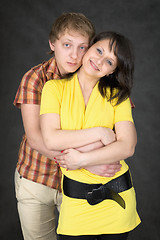 Image showing Couple embraces on a black background
