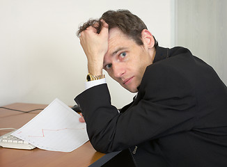 Image showing Sorrowful man at the office, on a workplace