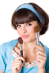 Image showing woman in blue dress with two make-up brushes