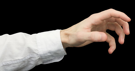 Image showing Greedy hand with crooked fingers on a black