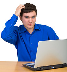 Image showing Young man comb head siting for laptop