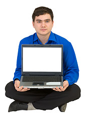 Image showing Guy sits on a floor with the laptop