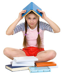 Image showing Young girl with book on head
