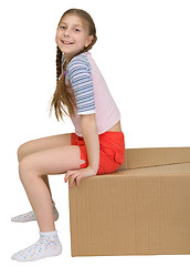 Image showing Girl sit on cardboard box