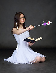 Image showing Girl - sorcerer with the book and a magic wand