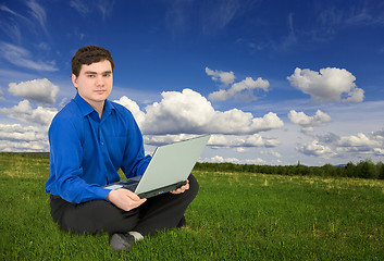 Image showing Young businessman work with laptop at the field