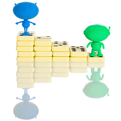 Image showing Two plastic aliens on a stairs from dominoes