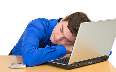 Image showing Young man sleeps with the laptop