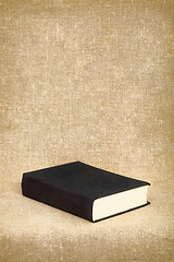 Image showing Black book on the fabric background