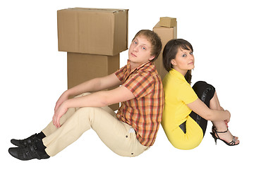 Image showing Guy and the girl sit near boxes