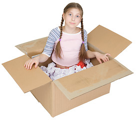 Image showing Little girl sits in a cardboard box