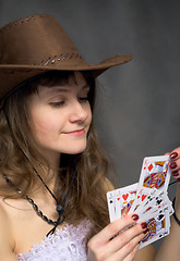 Image showing Cowgirl with a playing-cards in hand