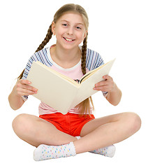 Image showing Small happy girl with the book in hands