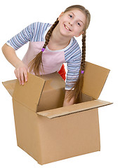 Image showing Girl thrust the hand into cardboard box