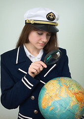 Image showing Sea captain looks at the globe