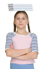 Image showing Girl with three books on a head