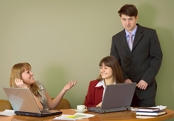 Image showing Girls at a desktop and their boss