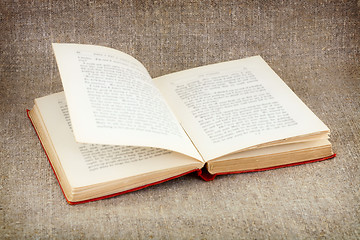 Image showing Open old book on canvas background